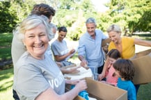 Happy volunteer family separating donations stuffs on a sunny day-2